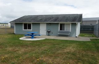 Picnic tables moved to a poured concrete pad and changed to an accessible design.