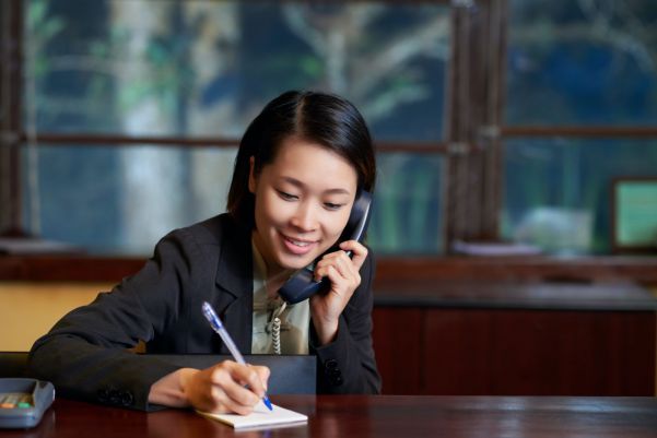 A hotel receptionist talking on the phone