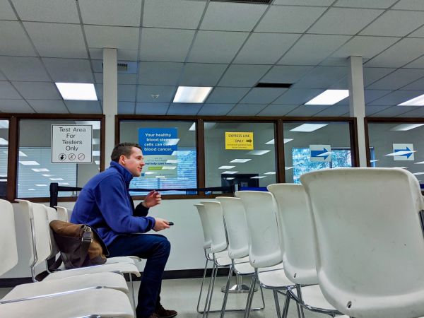A man sitting inside a DMV office
